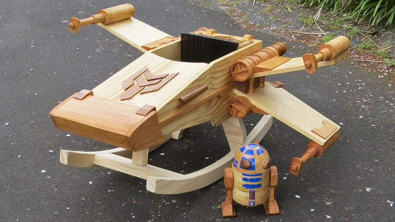 Illustration for article titled This Exquisite Wooden X-wing Rocker Will Make You Miss Being a Kid